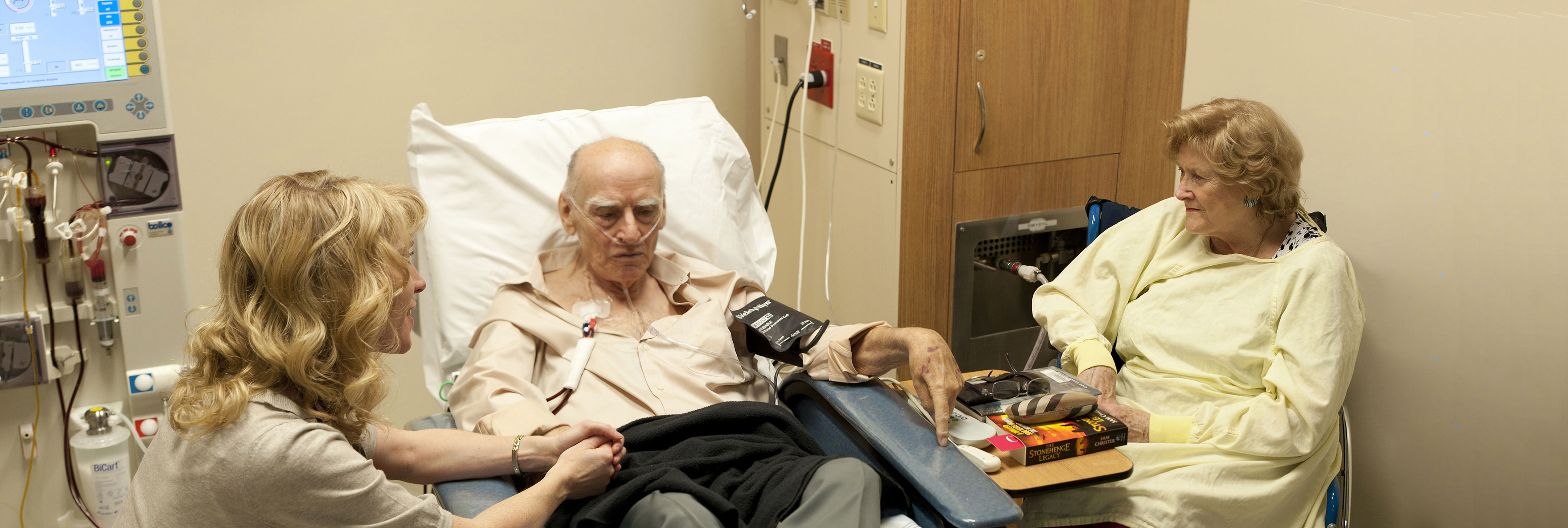 Dr. Sara Davison with patient and family member at dialysis unit