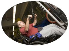 Man in wheelchair weightlifting