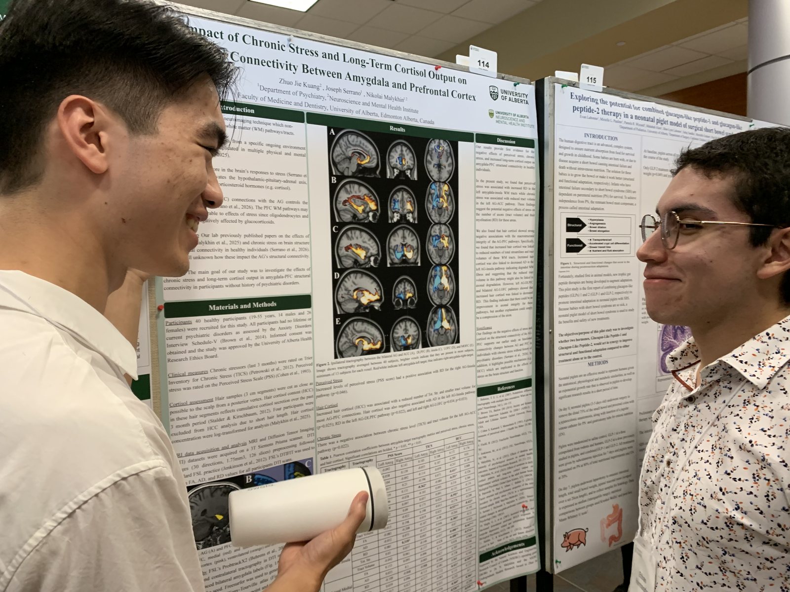 Jacky Kuang and Ethan Hernandez talking beside Jacky’s poster at FoMD Research Day