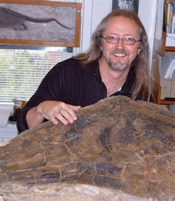 Paleontologist Dr. Michael Caldwell was surprised to find the fossil of a new species of marine reptile beneath a ping-pong table.