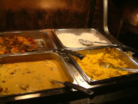 Two types of rice (white and saffron) with curry and potatoes.